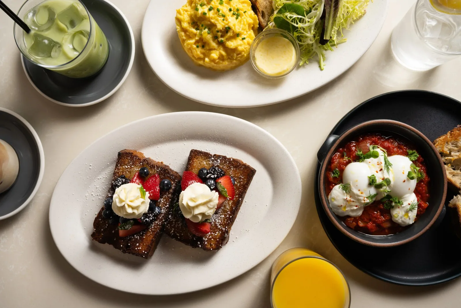 elegant brunch spread with french toast, scrambled eggs, shakshuka, and beverages., incommon, new york city