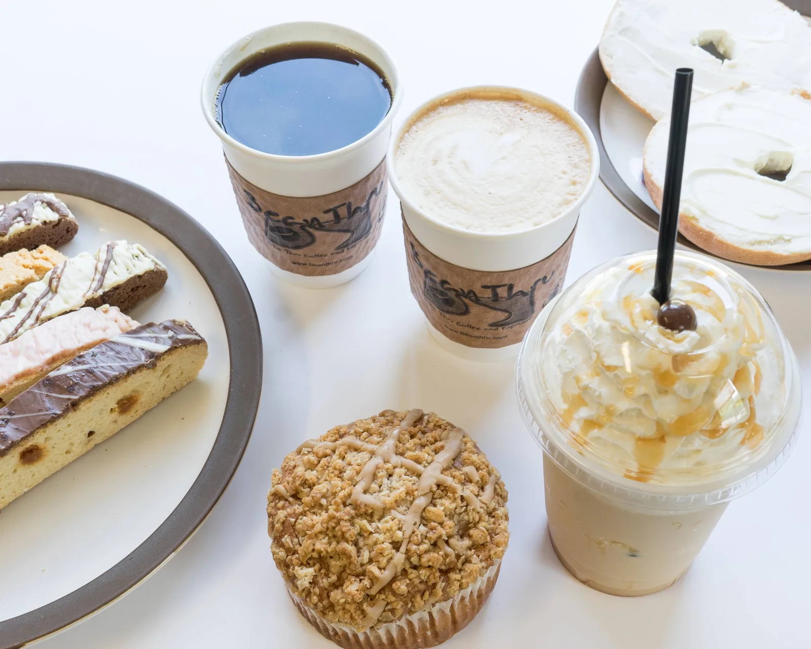 coffee shop pastries and beverages arranged on white surface with branded cups., inman coffee, cleveland