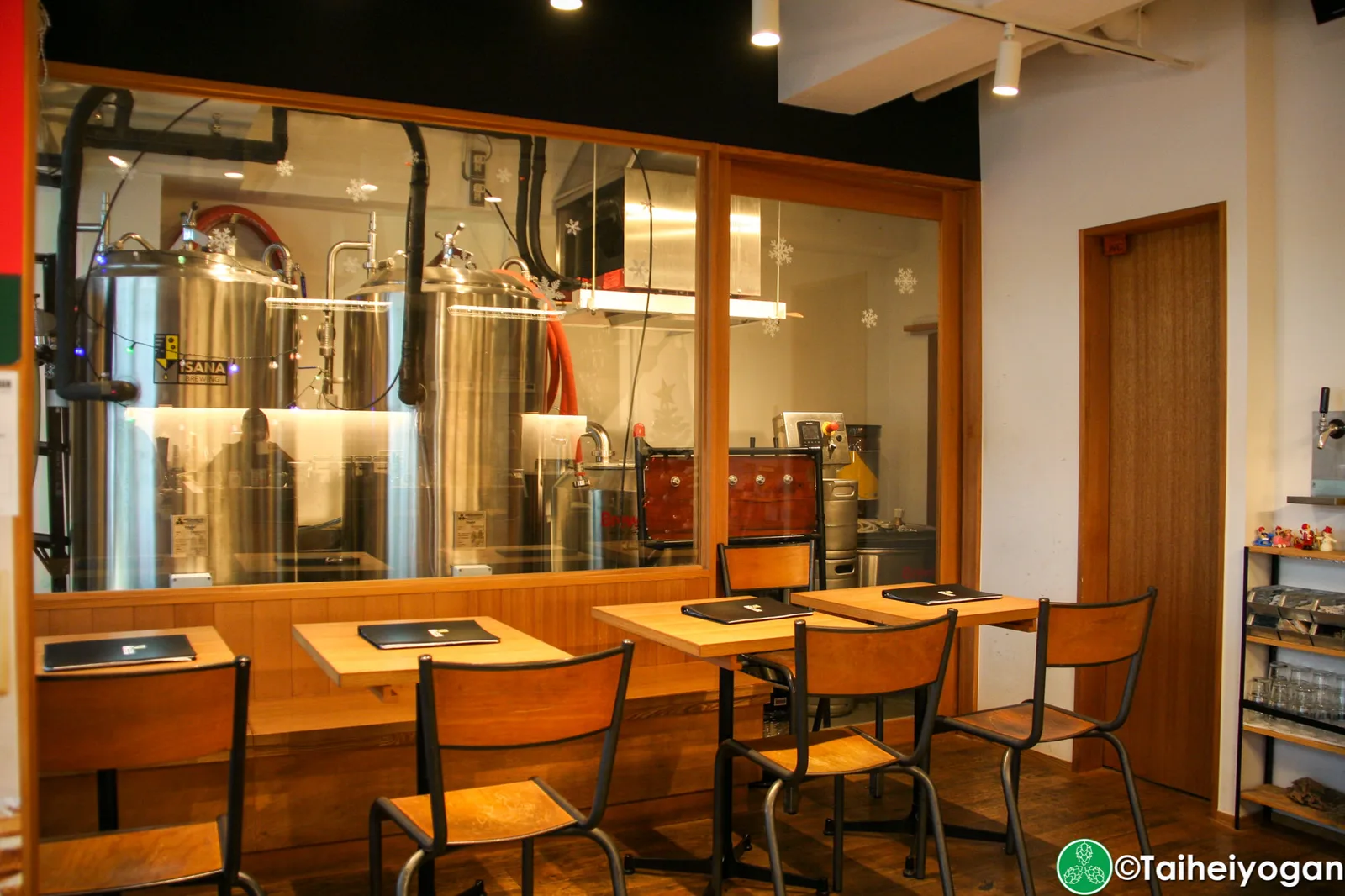 brewery tasting room with stainless steel fermentation tanks and wooden furniture., isana brewing brewery & roastery, tokyo