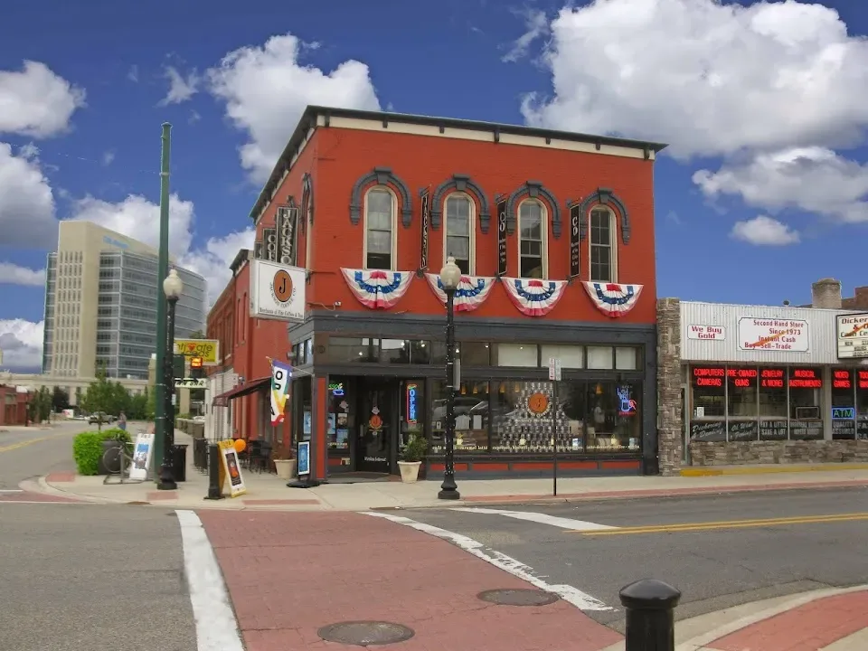historic red brick building with patriotic bunting on downtown street corner., jackson coffee company, michigan