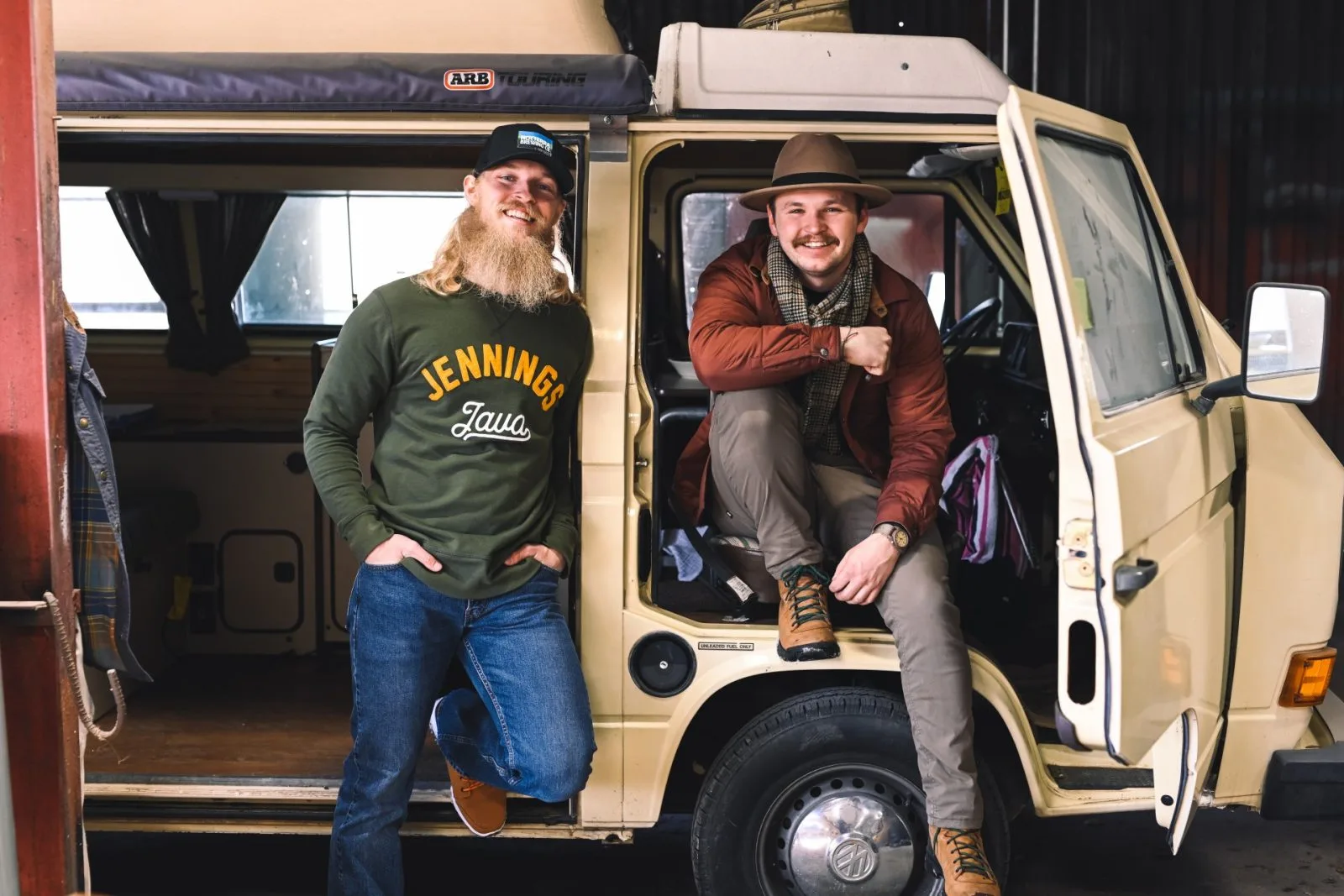 two bearded men posing in a cream-colored van with open doors., jennings java, columbus