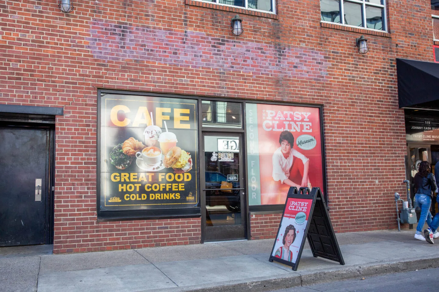 brick storefront with cafe and patsy cline museum signage and sandwich board., johnny cash museum, nashville