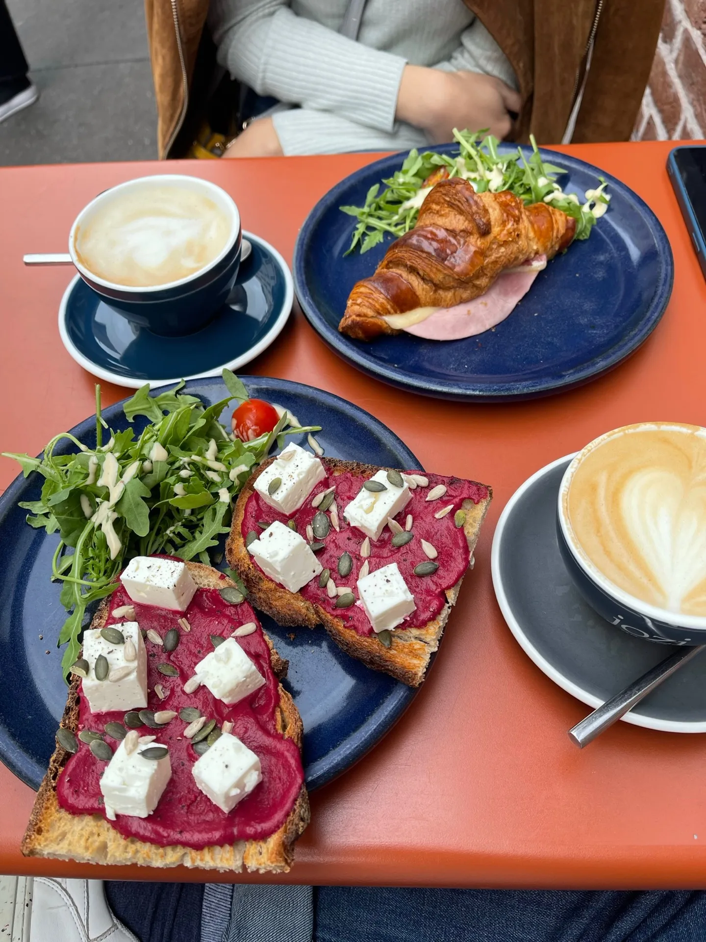 café brunch spread with beetroot toast, croissant sandwich, and latte coffees., jozi brunch, paris