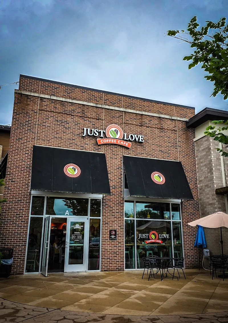 brick coffee shop storefront with black awnings and outdoor seating area., just love coffee cafe - the fountains at gateway, 