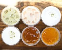 six clear glass bowls containing various sauces and condiments on wooden surface., just love coffee cafe - tomball, tx, houst