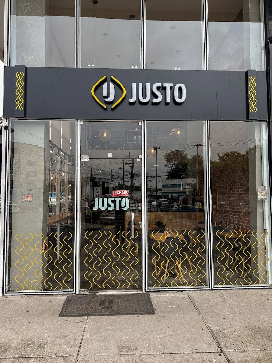 closed storefront with "justo" signage and gold geometric patterns on windows., justo café alcântara, são gonçalo