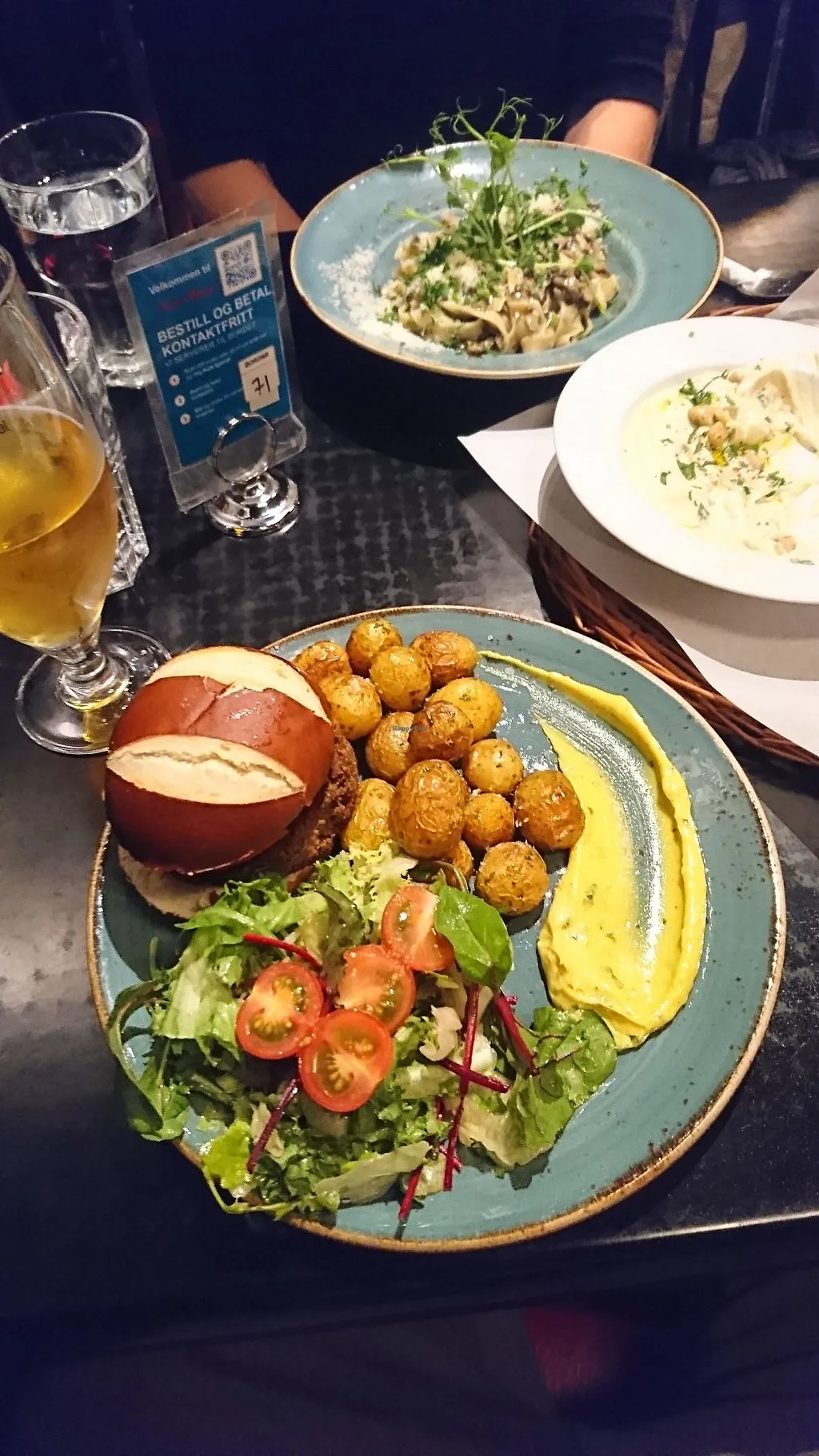 restaurant meal with burger, roasted potatoes, salad, pasta dishes, and beverages., kafé & restaurant spesial, bergen