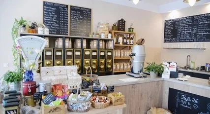 coffee shop counter with menu boards, plants, supplies, and pastry display., kaffee 26, berlin