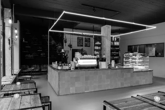 modern minimalist café interior with neon lighting and central service counter., kaffeekirsche, berlin