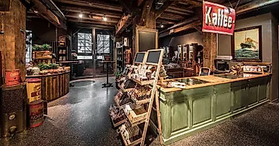 rustic workshop interior with wooden workbenches, tools, and vintage kathe signage., kaffeemuseum burg, hamburg