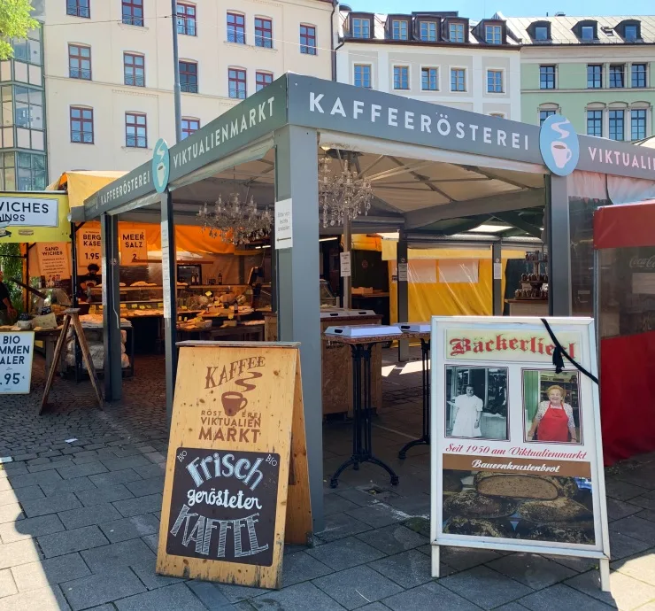 german market stall selling coffee and baked goods with historic signage displays., kaffeerösterei viktualienmarkt, munich