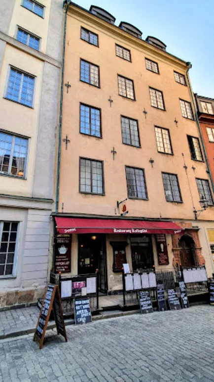historic european street with restaurant storefront and adjacent residential buildings., kaffegillet restaurang och café, sto