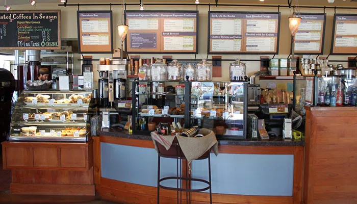 coffee shop counter with pastry display case and menu boards above., kean coffee, newport beach