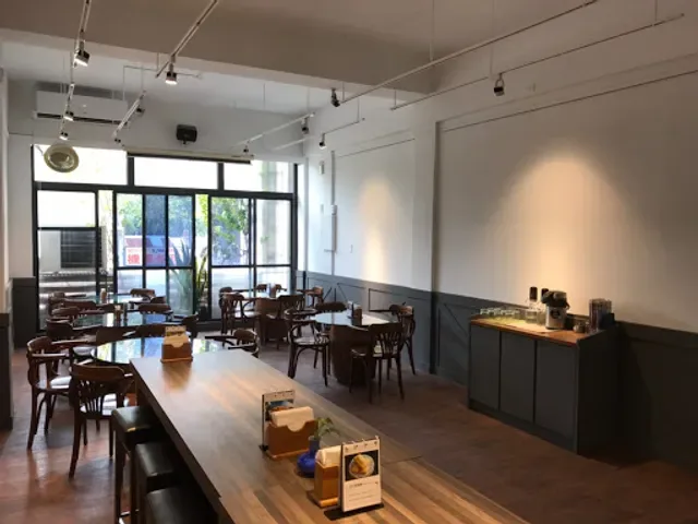 modern café interior with wooden tables, dark chairs, and track lighting throughout., kefi park roasters (ka-pi kong-hn̂g), t