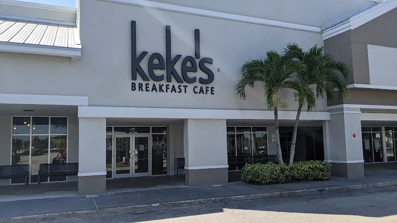kekes breakfast cafe storefront with palm tree and modern white building exterior., keke's breakfast cafe, port saint lucie