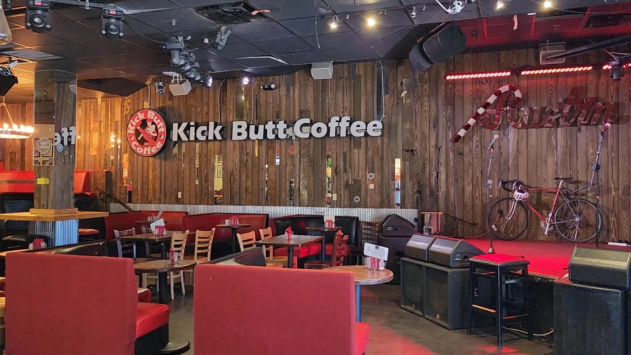 kick butt coffee shop interior with red seating, wooden walls, and bikes displayed., kick butt coffee, austin