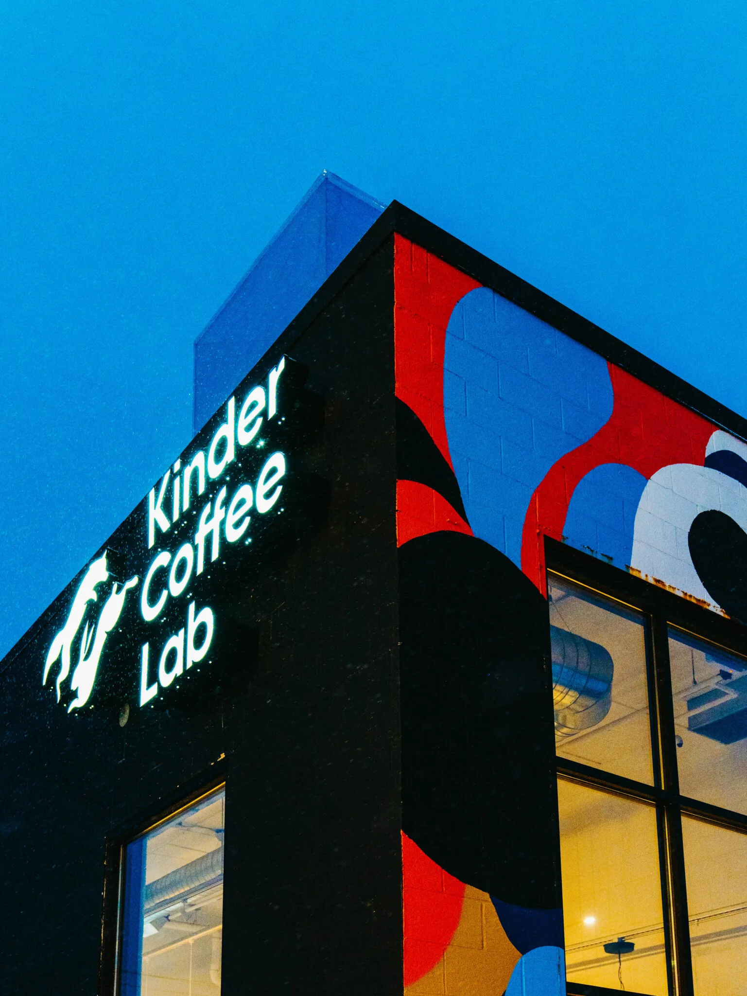 kindred coffee lab storefront with neon signage against clear blue sky., kinder coffee lab, saint cloud