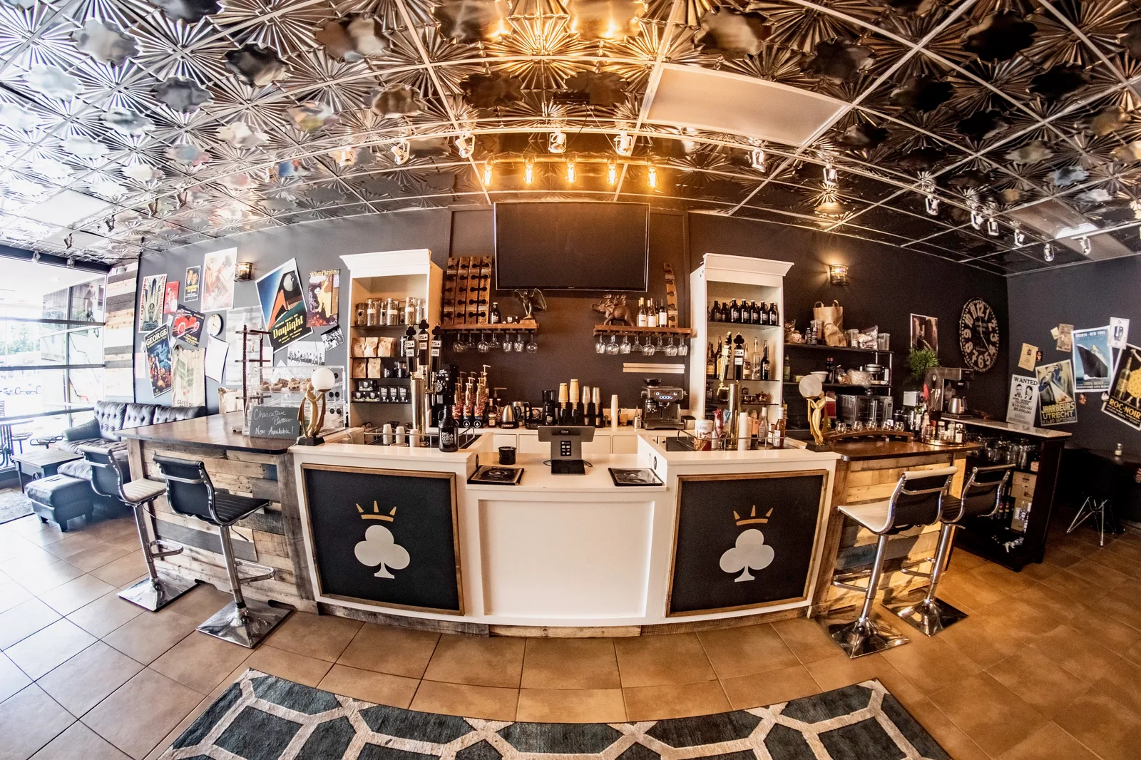upscale bar interior with ornate ceiling, shelved liquor bottles, and club-themed decor., king of clubs coffee & kombucha, vi