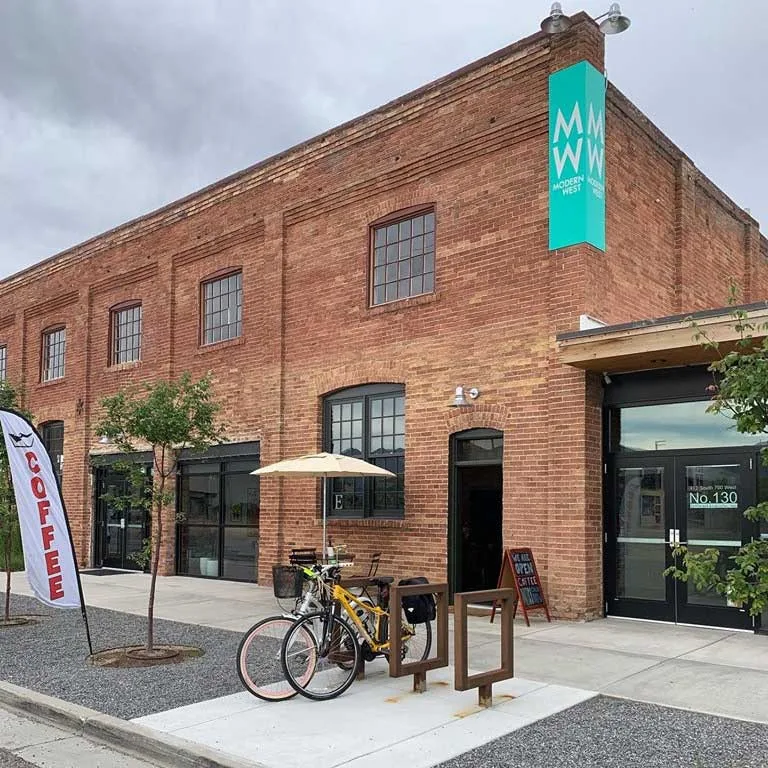 brick building with turquoise sign, bicycle parked outside, coffee shop entrance., kings peak coffee roasters, salt lake city