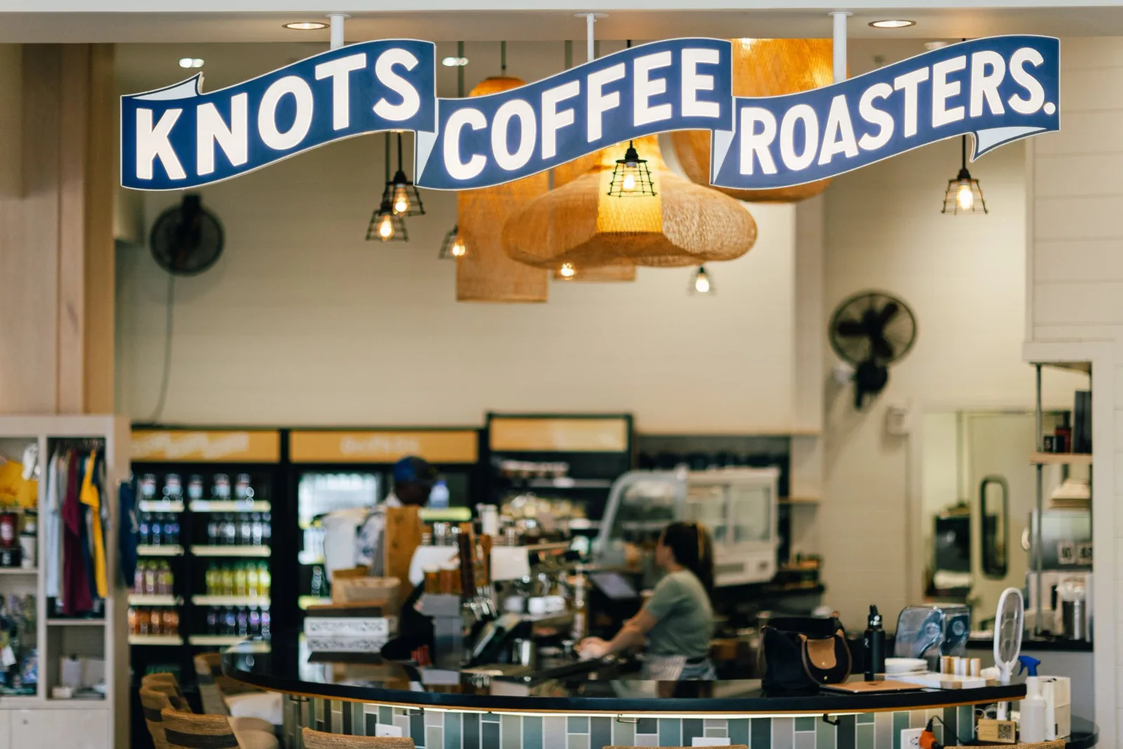 knots coffee roasters storefront with counter, staff, and hanging wooden light fixtures., knots coffee roasters, honolulu