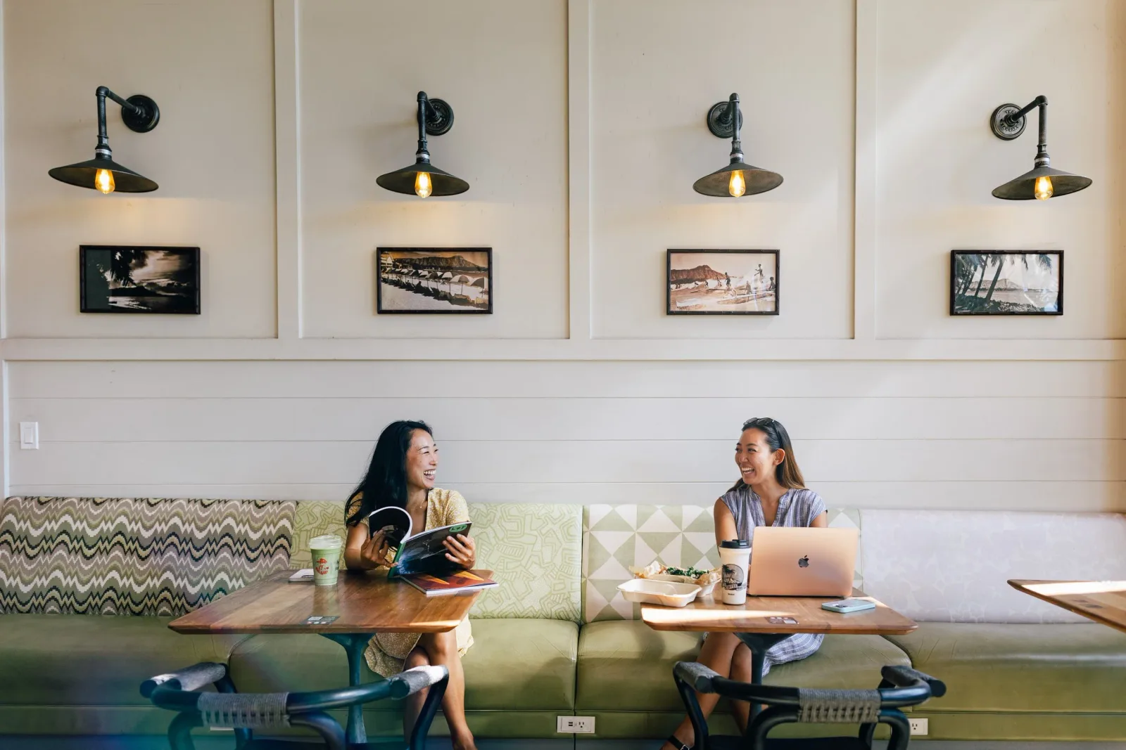 two women sitting in green booth seating, working with laptop and reading materials., knots coffee roasters, honolulu