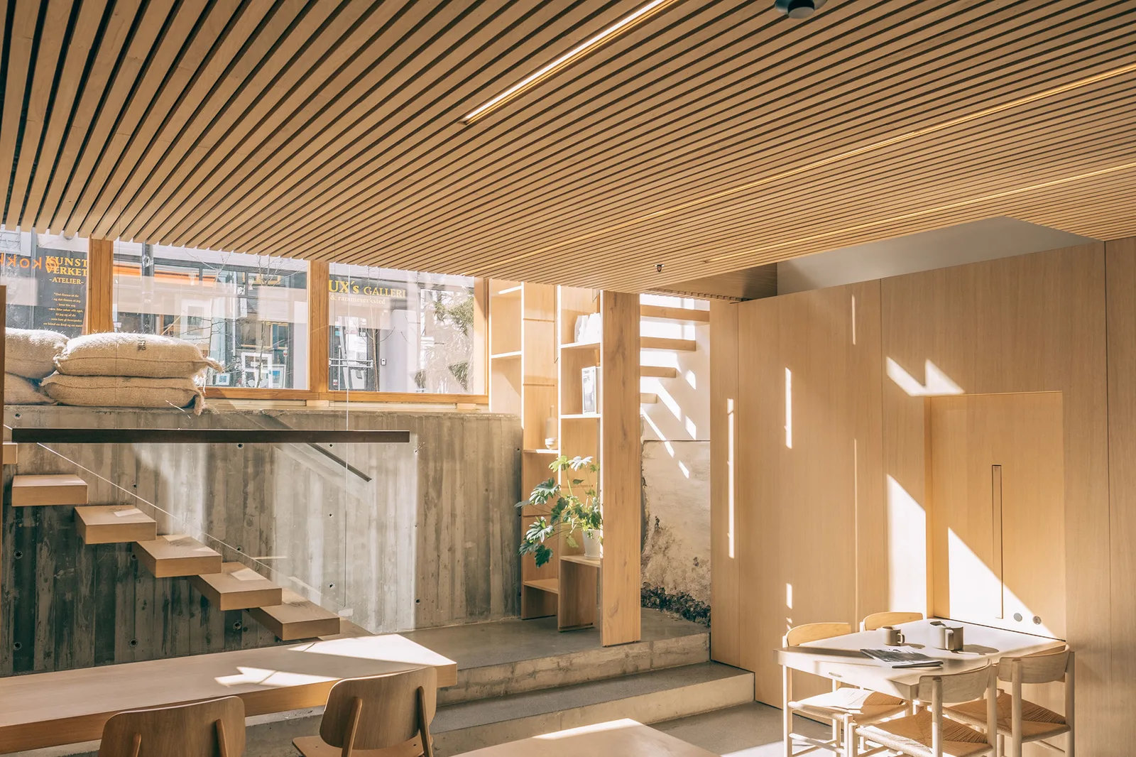 modern minimalist interior with wooden furniture, concrete walls, and natural light., kokko kaffebar, stavanger
