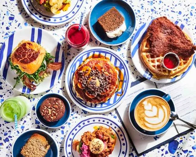 brunch spread with waffles, pancakes, burger, coffee, and fresh juices overhead view., kozy pompidou | all-week brunch | coff