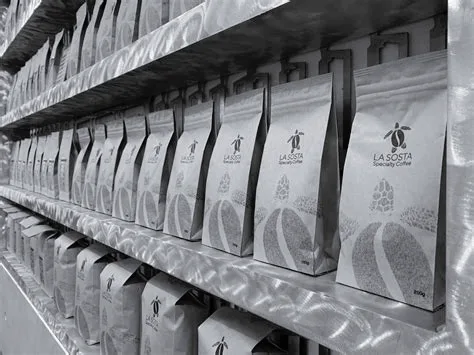 shelves displaying packaged products with black handles in organized rows., la sosta specialty coffee, impruneta