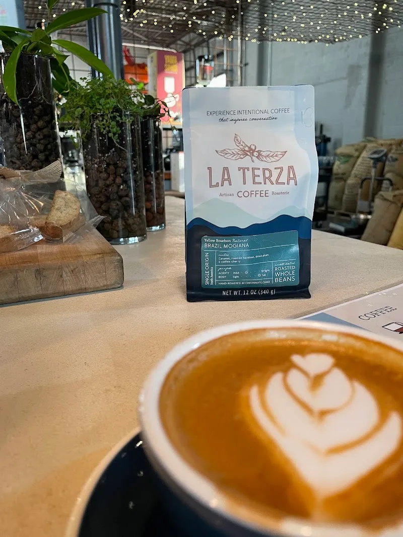 latte art coffee cup beside brazil mogiana coffee bag in modern café interior., la terza artisan coffee, ohio