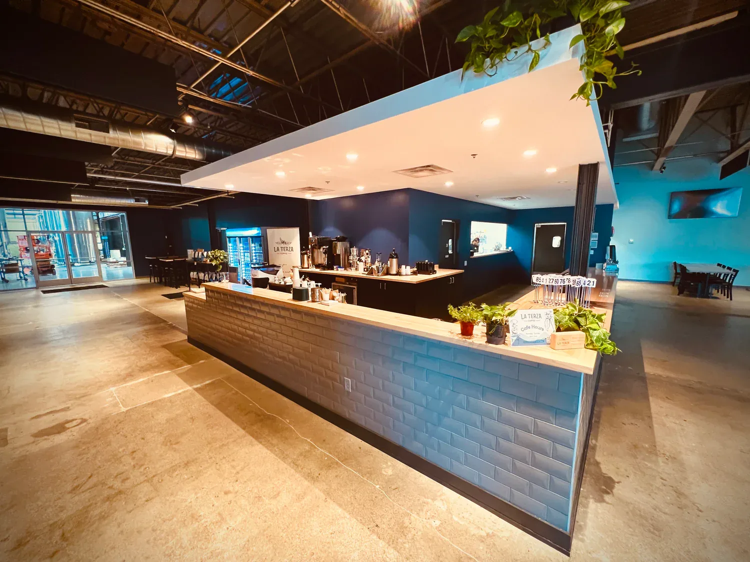 modern salon interior with curved reception desk and blue accent walls., la terza artisan coffee, ohio