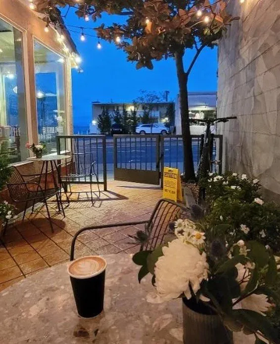 evening rooftop patio with coffee, seating, plants, and city view., laguna coffee company, laguna beach