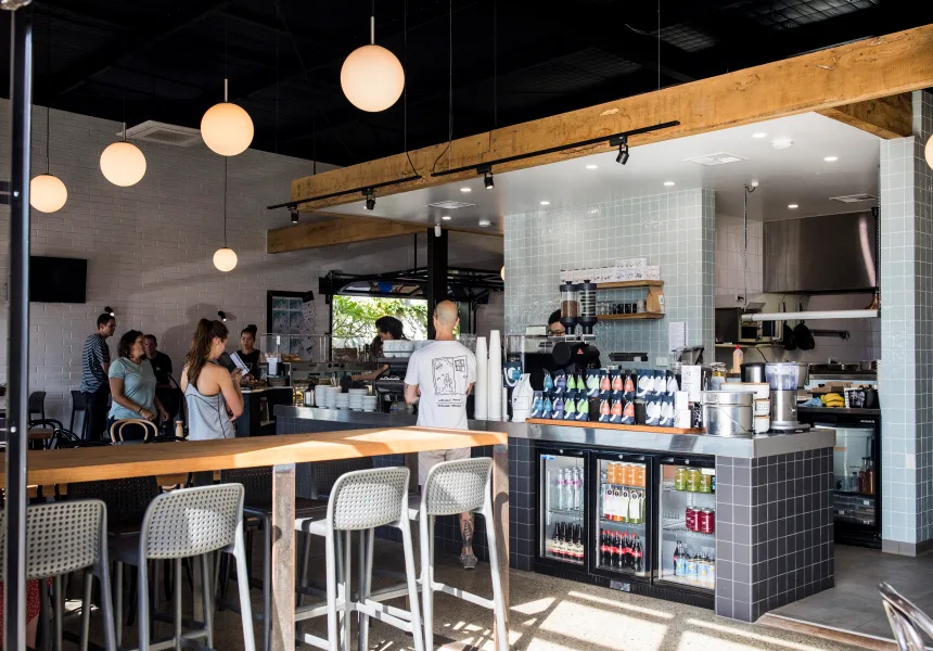 modern coffee shop interior with pendant lighting, wooden beam, and counter seating., laika coffee, lathlain