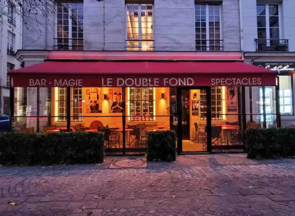 red awning storefront with glowing interior, parisian architecture, evening illumination., le double fond, paris