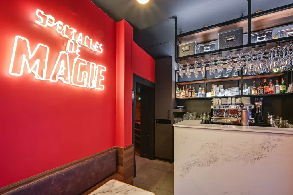 red neon "spectacles of magic" sign illuminates modern bar counter with shelving., le double fond, paris