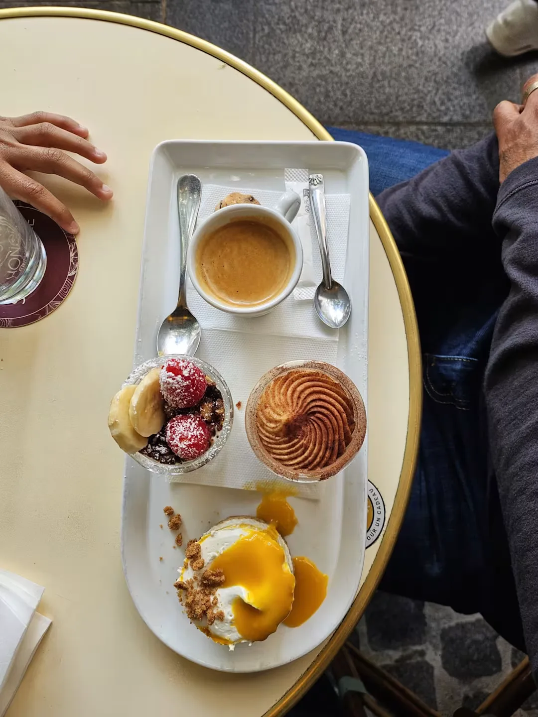 espresso cup with pastry assortment on white tray at café table., le passage saint honoré, paris
