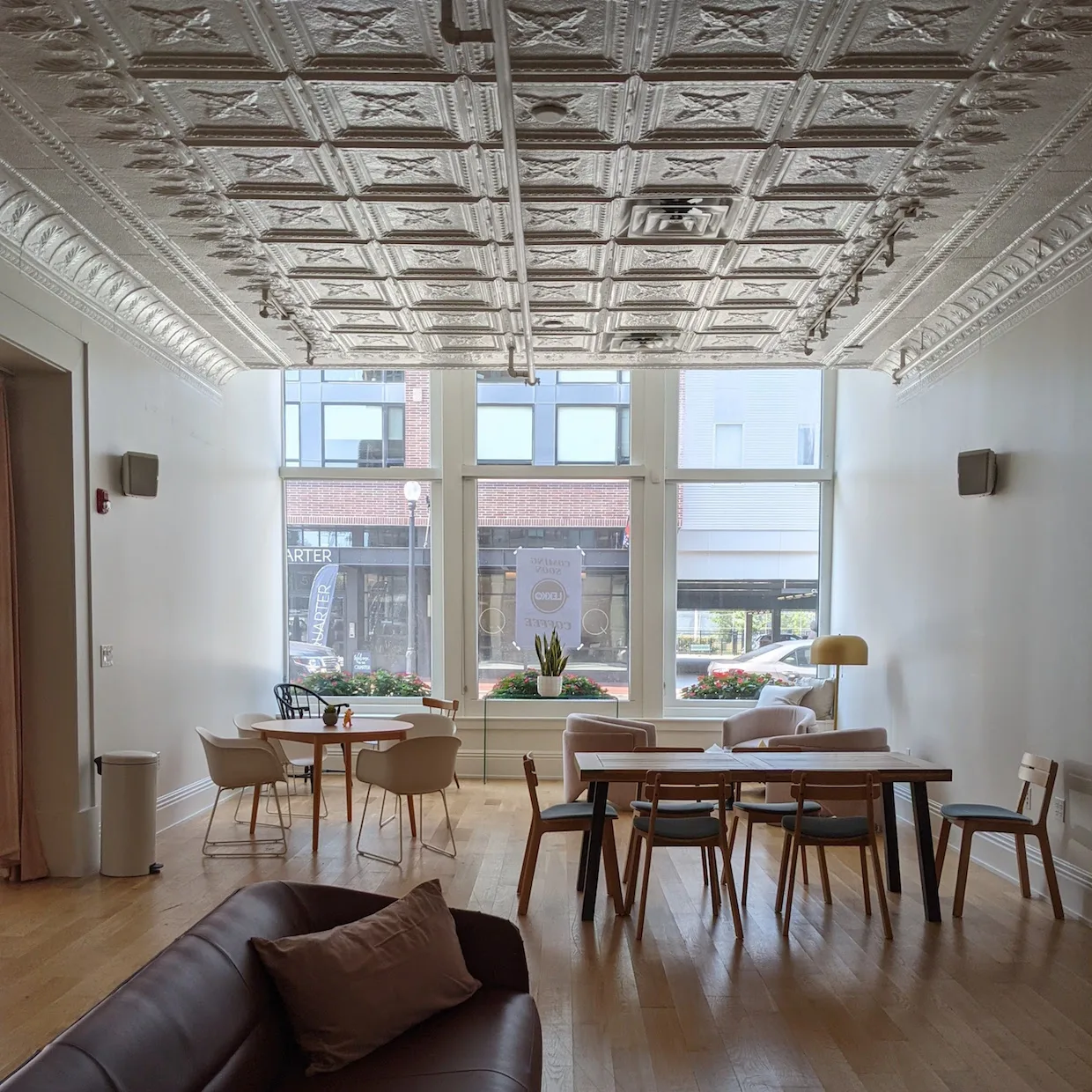 ornate tin ceiling, modern furniture, large windows overlooking urban street., lekko coffee, cleveland