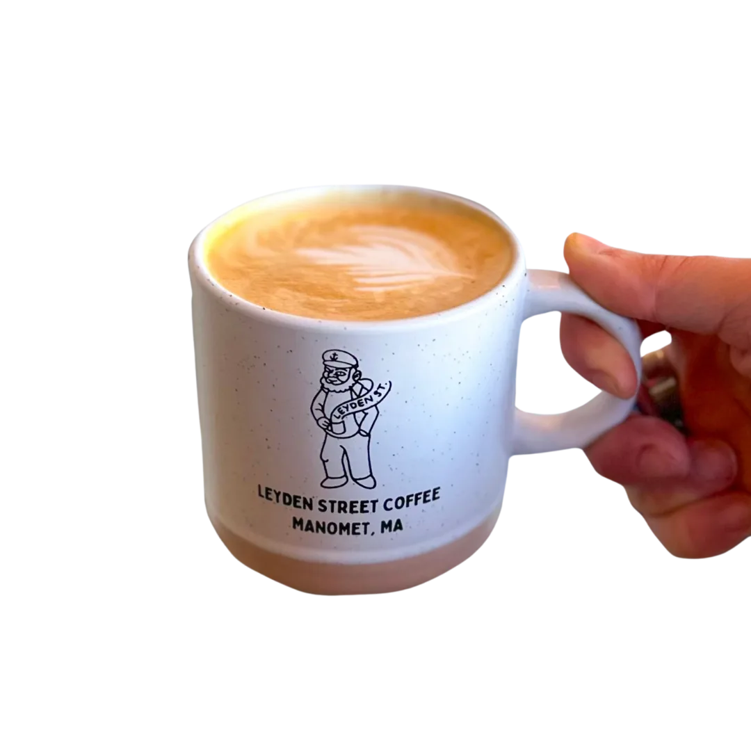 hand holding speckled white mug with latte art from leyden street coffee, manomet, ma., leyden street coffee equipment servic