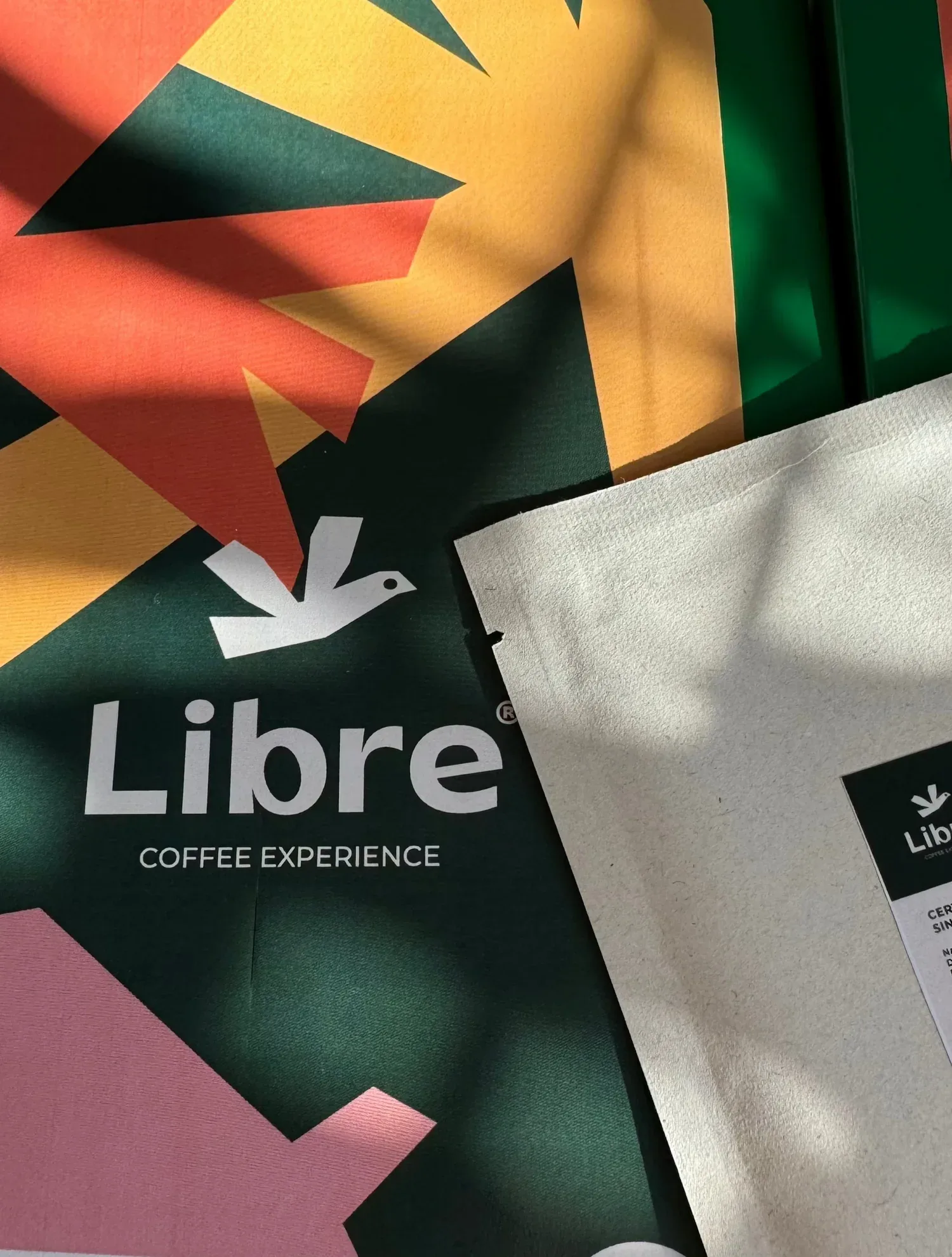 libre coffee experience branding materials with geometric design and dove logo., libre coffee experience, new york city