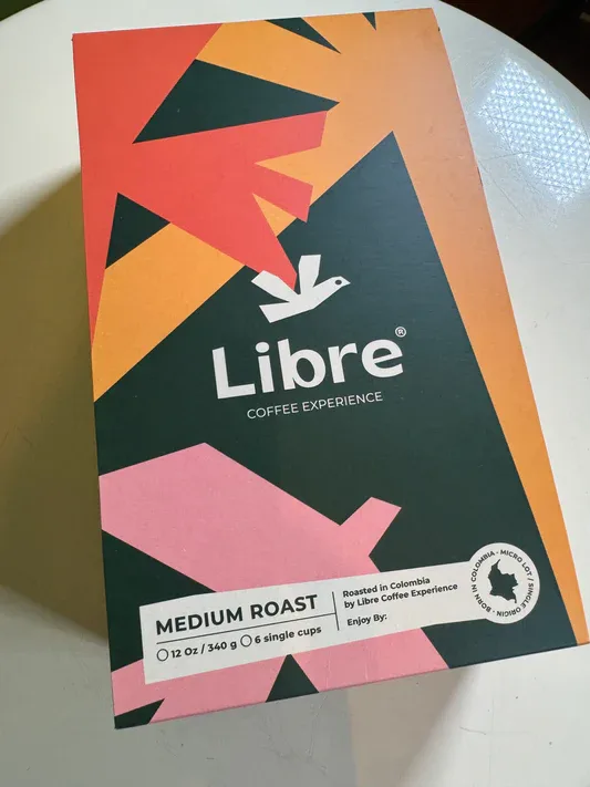 libre coffee experience medium roast box with geometric triangular design in warm colors., libre coffee experience, new york 