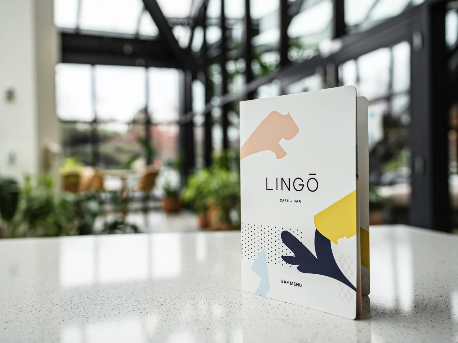 lingō cafe bar menu displayed on modern greenhouse interior with plants and natural light., lingo coffee, boston