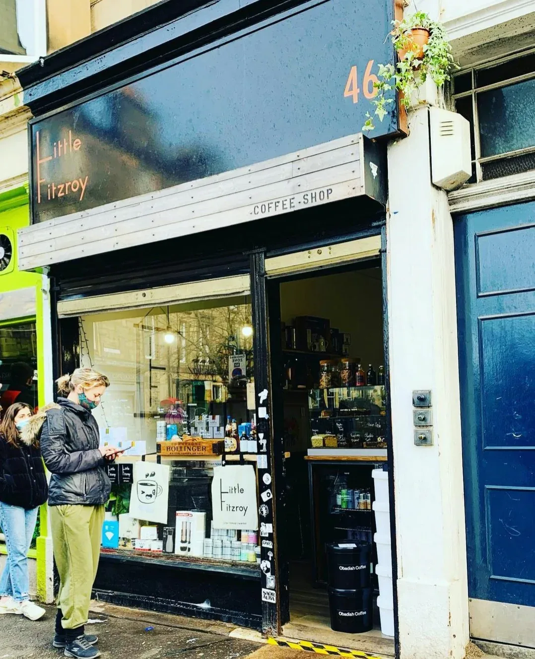 small independent coffee shop storefront with customers and hanging plants outside., little fitzroy coffee., edinburgh