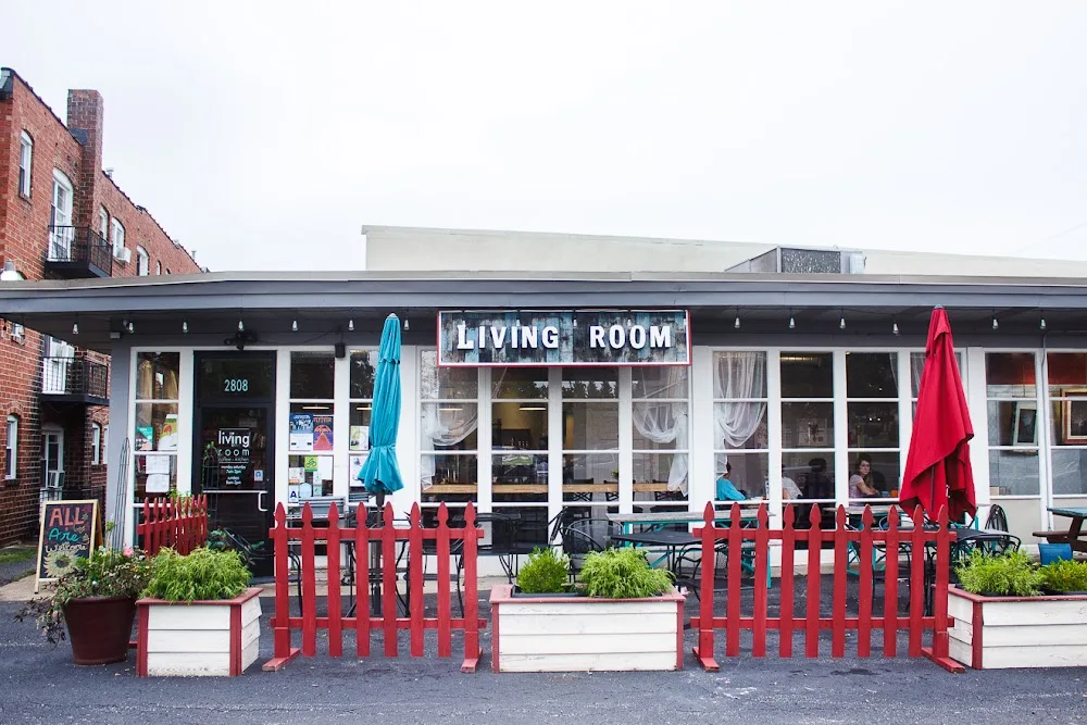 living room storefront with red picket fence, umbrellas, and outdoor seating area., living room coffee & kitchen, st. louis