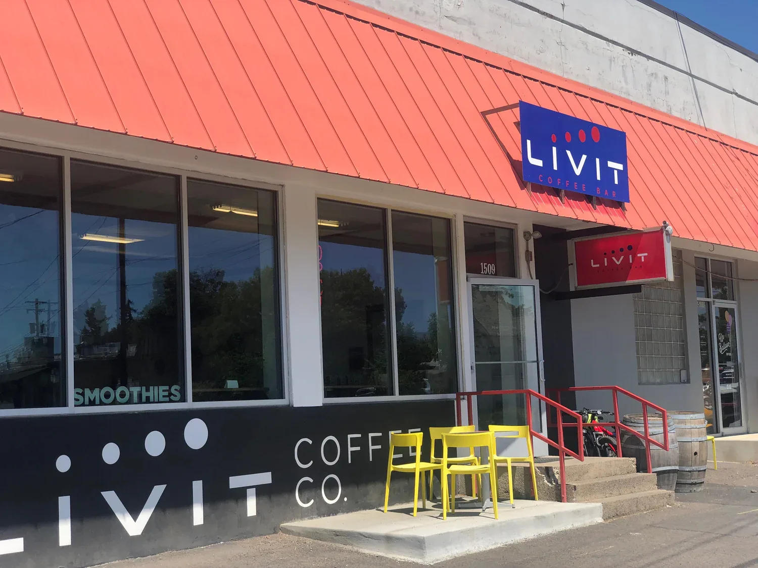 livit coffee bar storefront with coral roof, yellow chairs, and red railing entrance., livit coffee co., walla walla