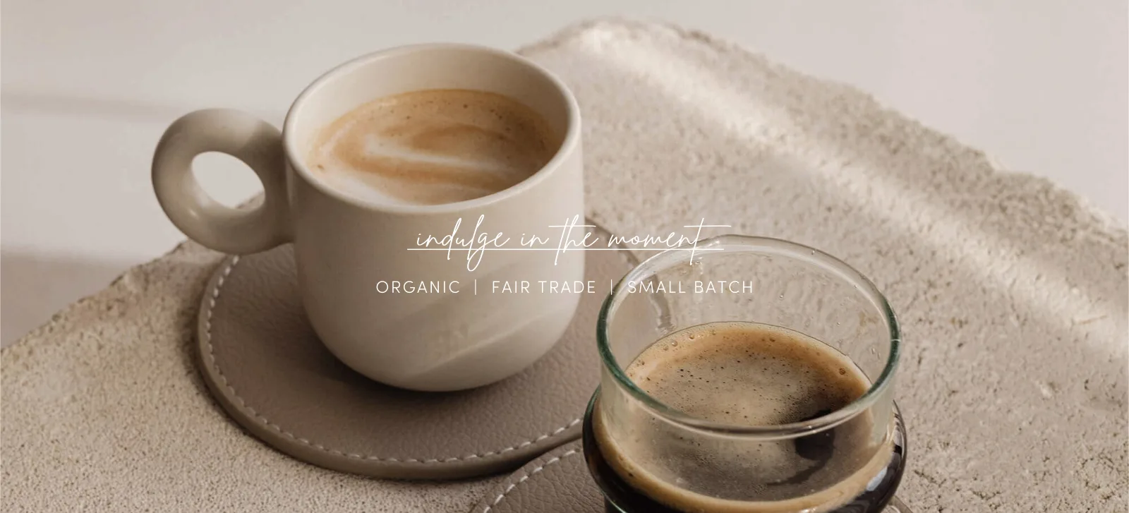 ceramic mug and glass cup of coffee on beige textile surface., low tide coffee roasters, san diego