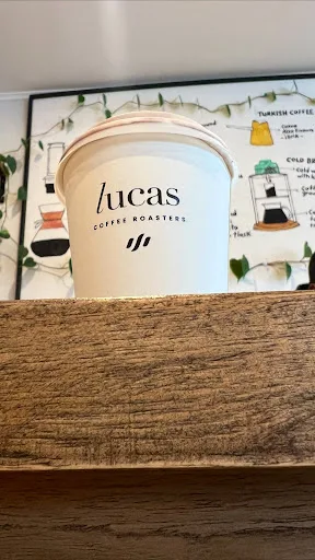 lucas coffee roasters canister displayed on wooden shelf with brewing guide., lucas coffee roasters, auckland