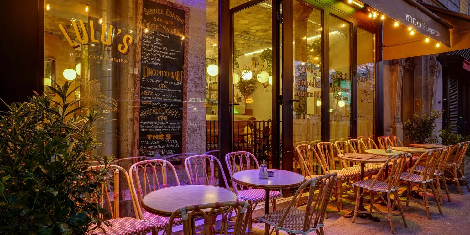 parisian café terrace at night with wicker chairs and warm lighting., lulu's, paris