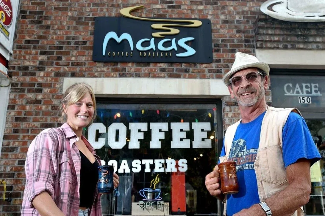 two people standing outside mags coffee roasters storefront holding beverages., maas coffee roasters, fort walton beach