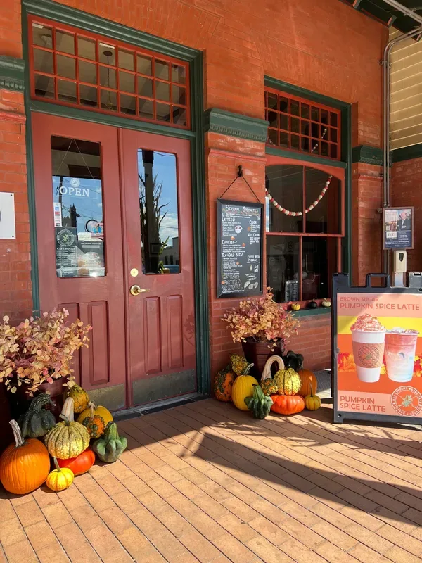autumn-decorated storefront with pumpkins, gourds, and pumpkin spice latte signage., mad anthony wayne cafe, wayne