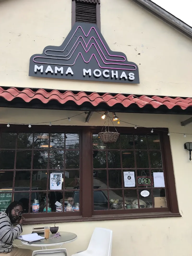 mama mochas café storefront with neon sign and outdoor seating area., mama mocha's coffee emporium & roasters, opelika