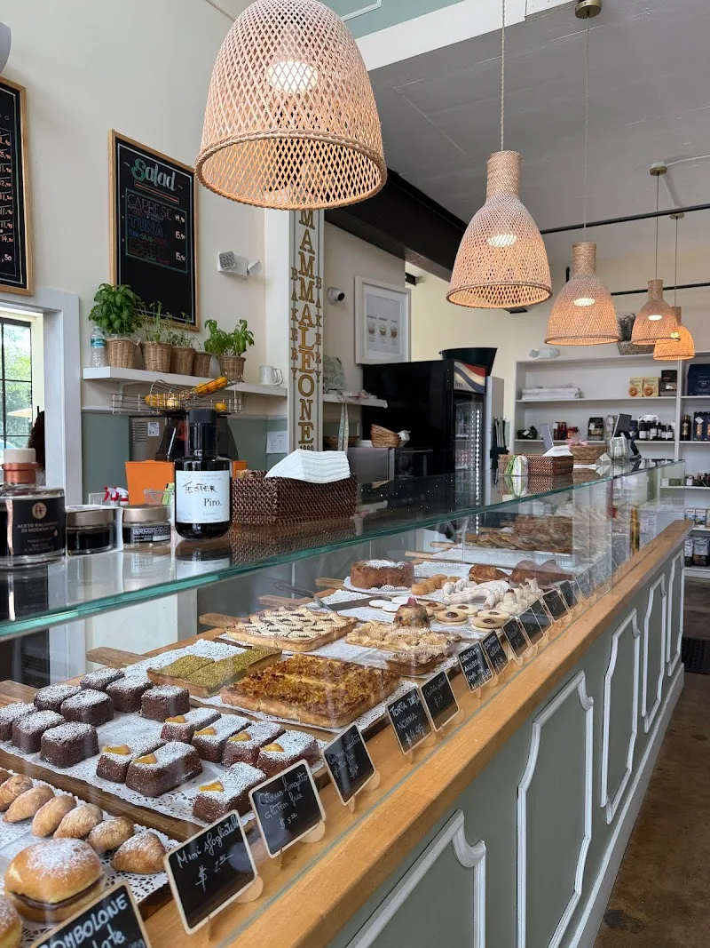modern bakery cafe with woven pendant lights and pastry display case., mamma leone, miami